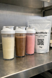BlendMade custom nutrition shake pouch with three freshly mixed shakes in shaker bottles